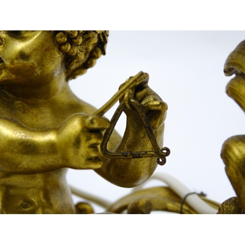 1532 - A pair of Continental gilt bronze twin branch table lamps, each modelled as a seated faun playing a ... 