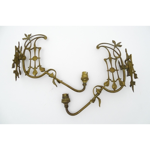 1533 - A pair of Art Nouveau brass wall lights with scrolling floral and foliate detail. Approx. 14