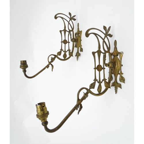 1533 - A pair of Art Nouveau brass wall lights with scrolling floral and foliate detail. Approx. 14