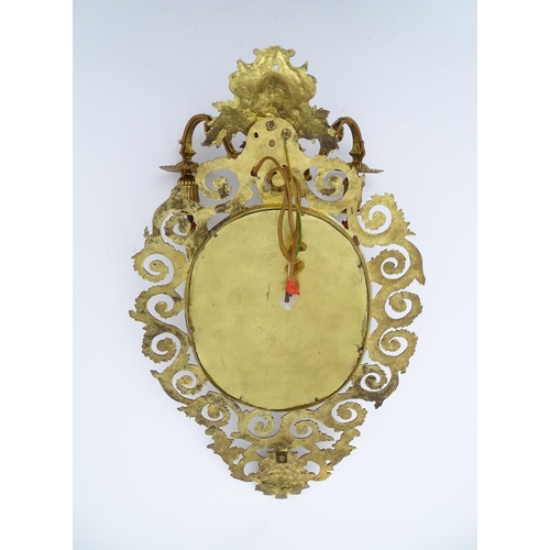 1548 - A 20thC girandole / electrolier with an oval bevelled mirror, three branches, with pierced and scrol... 