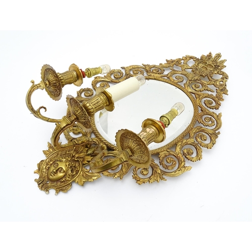 1548 - A 20thC girandole / electrolier with an oval bevelled mirror, three branches, with pierced and scrol... 