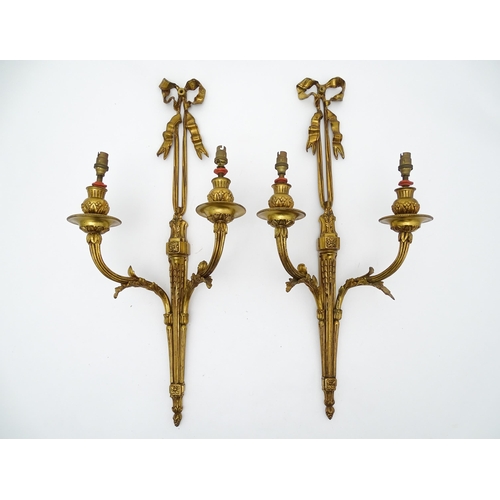 1550 - A pair of brass 20thC twin branch wall sconces with bow cresting and acanthus scroll detail. Approx.... 