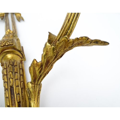 1550 - A pair of brass 20thC twin branch wall sconces with bow cresting and acanthus scroll detail. Approx.... 