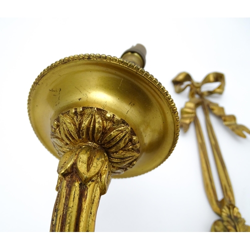 1550 - A pair of brass 20thC twin branch wall sconces with bow cresting and acanthus scroll detail. Approx.... 