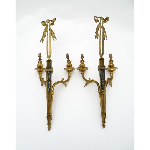 1550 - A pair of brass 20thC twin branch wall sconces with bow cresting and acanthus scroll detail. Approx.... 