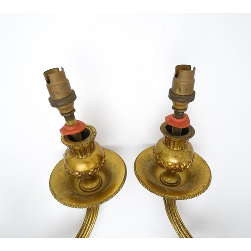 1550 - A pair of brass 20thC twin branch wall sconces with bow cresting and acanthus scroll detail. Approx.... 