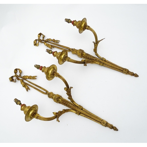 1550 - A pair of brass 20thC twin branch wall sconces with bow cresting and acanthus scroll detail. Approx.... 