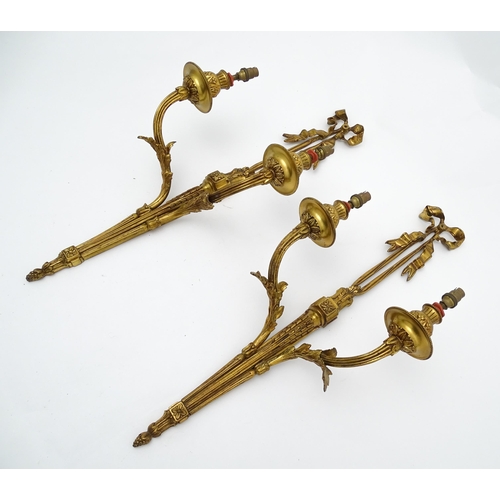 1550 - A pair of brass 20thC twin branch wall sconces with bow cresting and acanthus scroll detail. Approx.... 