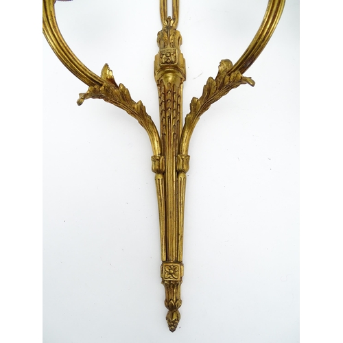 1550 - A pair of brass 20thC twin branch wall sconces with bow cresting and acanthus scroll detail. Approx.... 