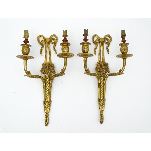 1551 - A pair of 20thC brass two branch wall sconces with bow cresting and fruiting cornucopia detail detai... 