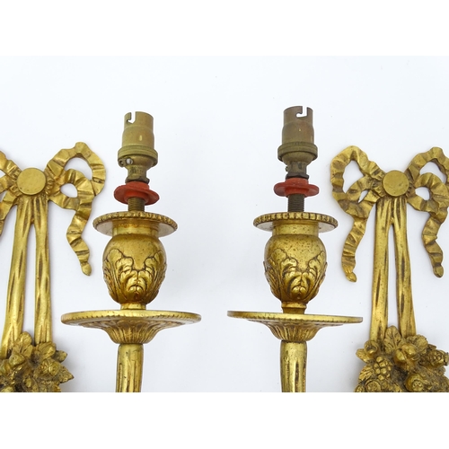 1551 - A pair of 20thC brass two branch wall sconces with bow cresting and fruiting cornucopia detail detai... 