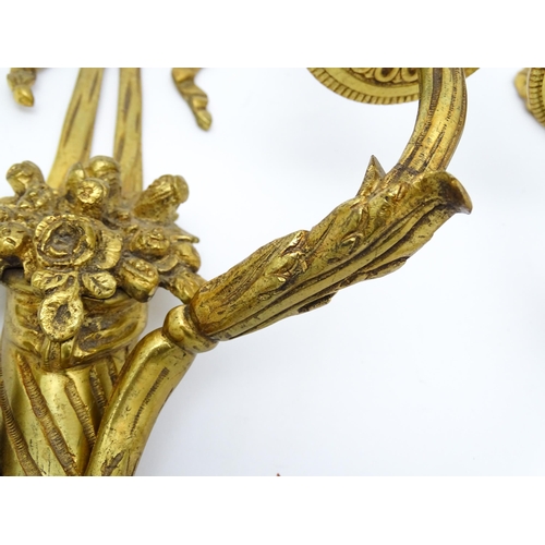 1551 - A pair of 20thC brass two branch wall sconces with bow cresting and fruiting cornucopia detail detai... 