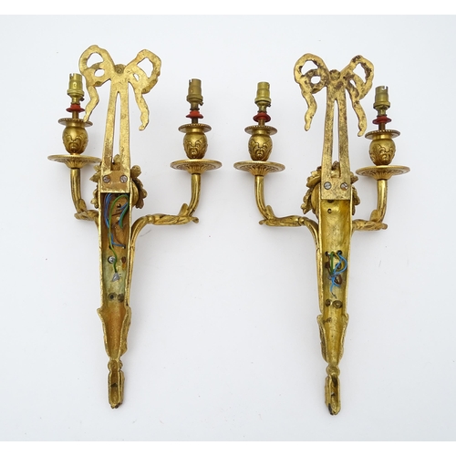 1551 - A pair of 20thC brass two branch wall sconces with bow cresting and fruiting cornucopia detail detai... 