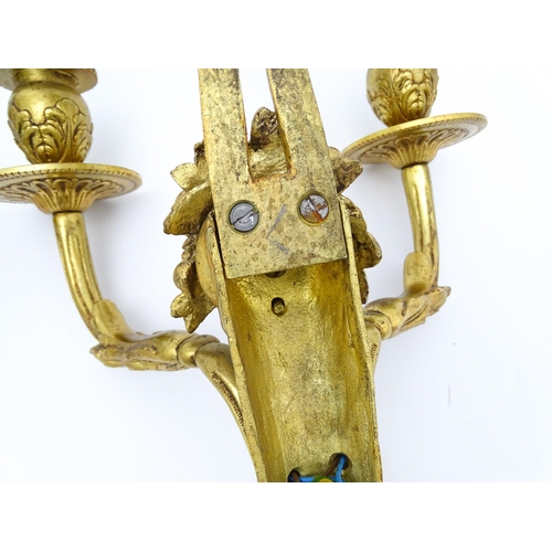 1551 - A pair of 20thC brass two branch wall sconces with bow cresting and fruiting cornucopia detail detai... 