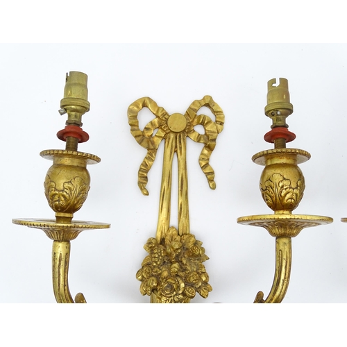 1551 - A pair of 20thC brass two branch wall sconces with bow cresting and fruiting cornucopia detail detai... 