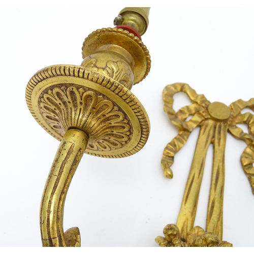 1551 - A pair of 20thC brass two branch wall sconces with bow cresting and fruiting cornucopia detail detai... 