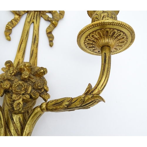 1551 - A pair of 20thC brass two branch wall sconces with bow cresting and fruiting cornucopia detail detai... 