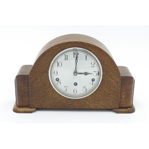 1514 - A mid 20thC oak cased 8 day mantel clock by Garrard. Approx. 9 1/4