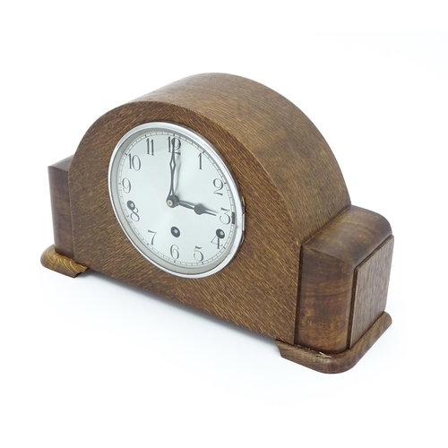 1514 - A mid 20thC oak cased 8 day mantel clock by Garrard. Approx. 9 1/4