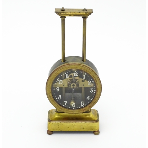 1515 - A gilt brass cased gravity clock, the dial with Arabic numerals. Approx. 9 1/2