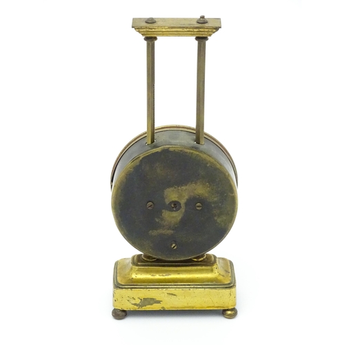 1515 - A gilt brass cased gravity clock, the dial with Arabic numerals. Approx. 9 1/2