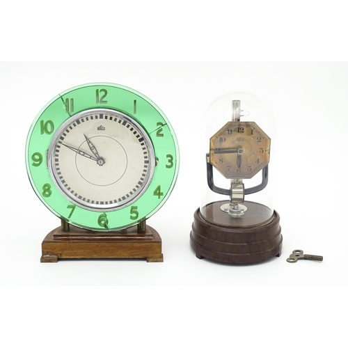 1517 - A Bulle type electric clock on Bakelite style base. Together with a mid century Bulle electric clock... 