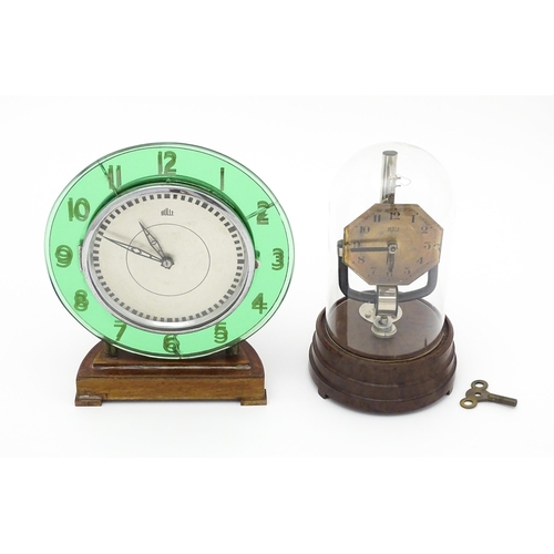 1517 - A Bulle type electric clock on Bakelite style base. Together with a mid century Bulle electric clock... 