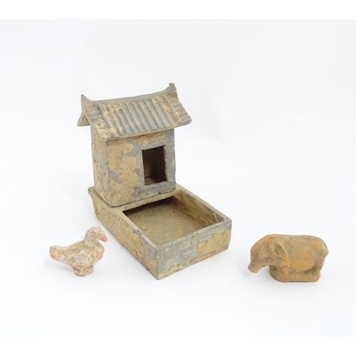 1033 - A Chinese Han dynasty pottery model of a pig sty with hut, a model of a boar and a model of a duck. ... 