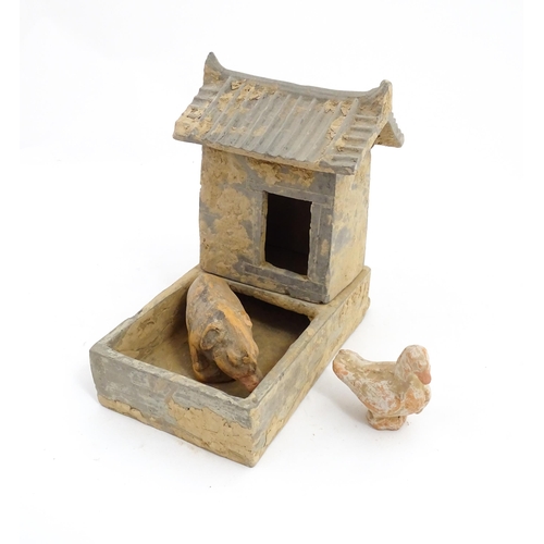 1033 - A Chinese Han dynasty pottery model of a pig sty with hut, a model of a boar and a model of a duck. ... 