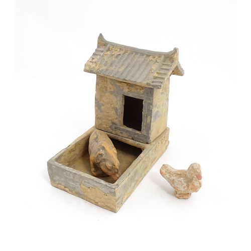 1033 - A Chinese Han dynasty pottery model of a pig sty with hut, a model of a boar and a model of a duck. ... 