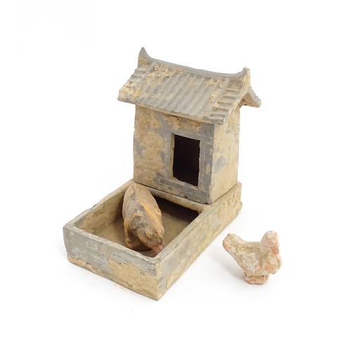 1033 - A Chinese Han dynasty pottery model of a pig sty with hut, a model of a boar and a model of a duck. ... 