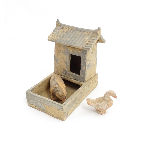 1033 - A Chinese Han dynasty pottery model of a pig sty with hut, a model of a boar and a model of a duck. ... 