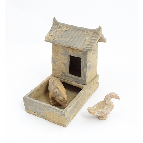 1033 - A Chinese Han dynasty pottery model of a pig sty with hut, a model of a boar and a model of a duck. ... 