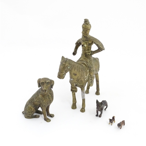 1077 - Four Victorian and later models of dogs to include a cast brass Setter, a carved wooden charm modell... 