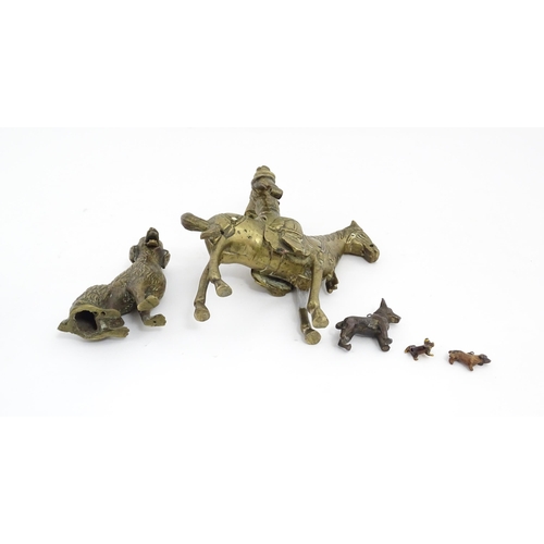 1077 - Four Victorian and later models of dogs to include a cast brass Setter, a carved wooden charm modell... 