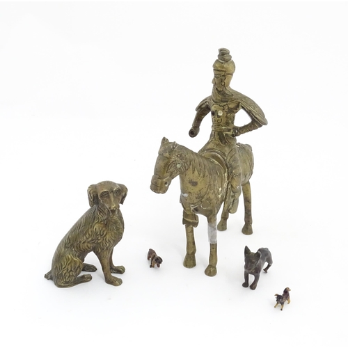 1077 - Four Victorian and later models of dogs to include a cast brass Setter, a carved wooden charm modell... 