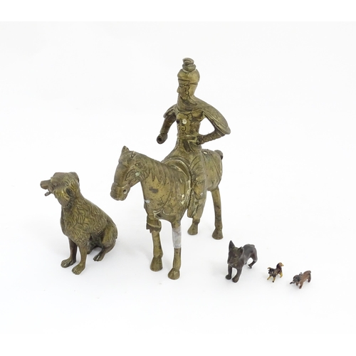 1077 - Four Victorian and later models of dogs to include a cast brass Setter, a carved wooden charm modell... 