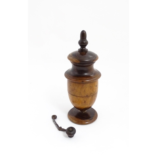 1123 - Treen : An 18thC lignum vitae spice / coffee grinder of urn form, the iron spigot concealed by an ac... 