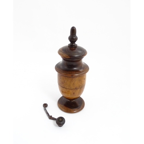 1123 - Treen : An 18thC lignum vitae spice / coffee grinder of urn form, the iron spigot concealed by an ac... 