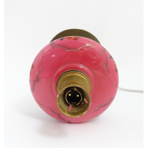 1536 - An Art & Crafts brass oil lamp with pink glass reservoir, converted to an electric table lamp. Appro... 