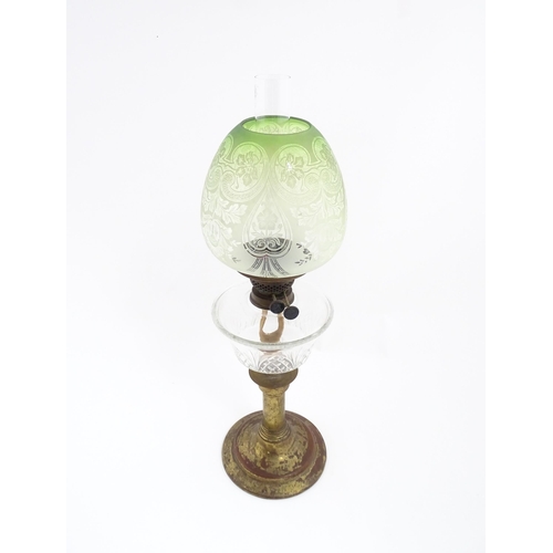 1538 - A Victorian oil lamp with cut glass reservoir and green etched glass shade. Approx. 24