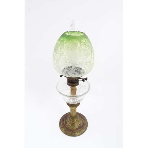 1538 - A Victorian oil lamp with cut glass reservoir and green etched glass shade. Approx. 24