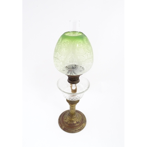 1538 - A Victorian oil lamp with cut glass reservoir and green etched glass shade. Approx. 24