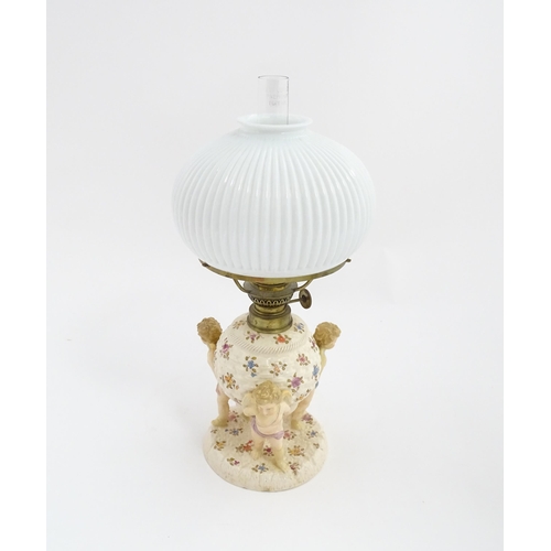 1540 - A Continental oil lamp, the German Sitzendorf style base with cherubs detail and floral decoration. ... 