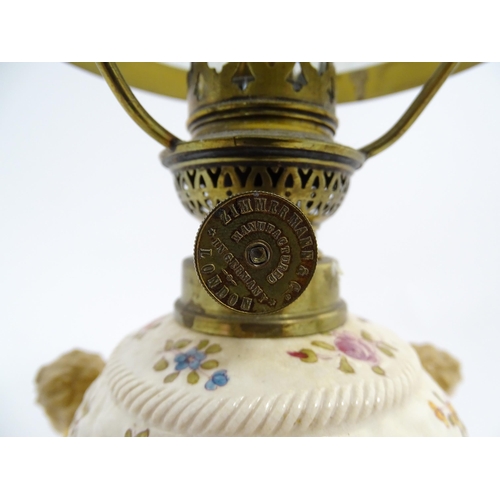 1540 - A Continental oil lamp, the German Sitzendorf style base with cherubs detail and floral decoration. ... 