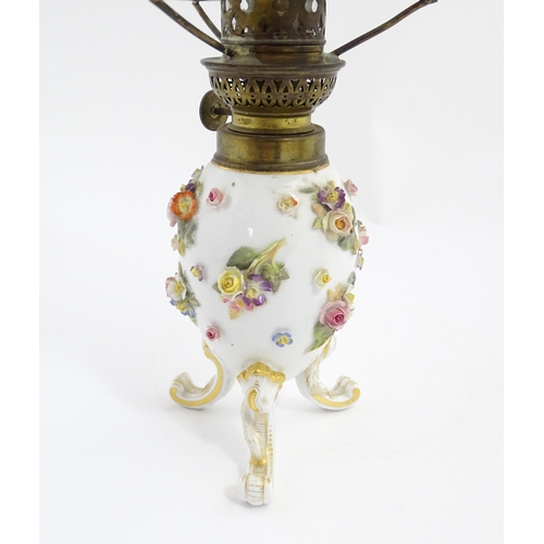 1541 - A Continental oil lamp with encrusted flower decoration, with Meissen style crossed sword marks unde... 