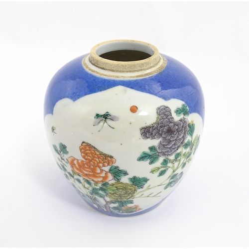 27 - A Chinese famille verte ginger jar decorated with floral panels and insects on a blue ground. Approx... 