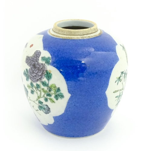 27 - A Chinese famille verte ginger jar decorated with floral panels and insects on a blue ground. Approx... 