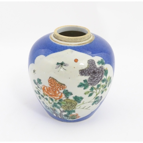 27 - A Chinese famille verte ginger jar decorated with floral panels and insects on a blue ground. Approx... 