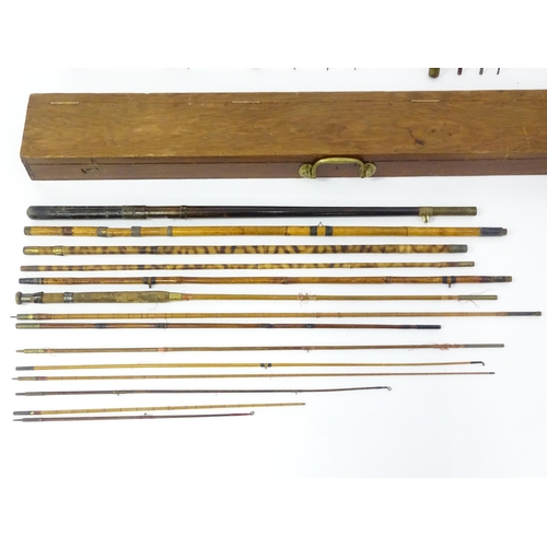 1305 - Fishing: a late 19thC fishing rod box , containing a quantity of split cane, bamboo and greenheart r... 